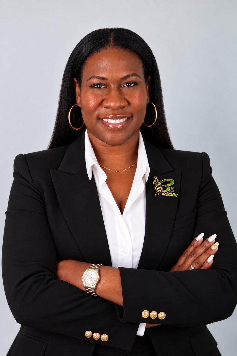 Helen D. Miller, MBA, Founder of Be The Lender, in a black blazer wearing the Be The Lender logo pin